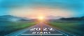 New year 2022 or start straight concept. word 2022 written on the road in the middle of asphalt road at sunset. Concept of plannin Royalty Free Stock Photo