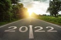 New year 2022 or straightforward concept. Text 2022 written on the road in the middle of asphalt road at sunset.Concept of plannin