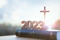 2023 new year sunrise, the cross of Jesus Christ and the Bible