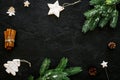 New year symbols. Spruce branch, cones and toys for decoration like spruce and stras on black background top view copy