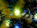 New Year tinsel with neon lights on a Christmas tree closeup Royalty Free Stock Photo