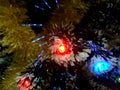 New Year tinsel with neon lights on a Christmas tree closeup Royalty Free Stock Photo