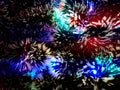 New Year tinsel with neon lights on a Christmas tree closeup Royalty Free Stock Photo