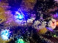 New Year tinsel with neon lights on a Christmas tree closeup Royalty Free Stock Photo