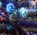 New Year tinsel with neon lights on a Christmas tree closeup Royalty Free Stock Photo