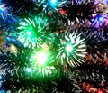 New Year tinsel with neon lights on a Christmas tree closeup Royalty Free Stock Photo