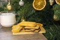 New Year tree with dry orange slices. Milk and biscuits for Santa Claus. Christmas still life