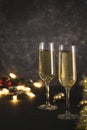 New year 2021 - two glasses of champagne on a dark background with bokeh from garlands Royalty Free Stock Photo