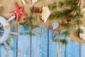 New Year vacation holiday sailor's captain's wheel with seashells, starfish, sand, blue wooden boards