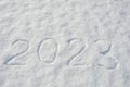 New year 2023. figures in the snow. number on a white background.