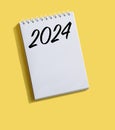 New Year 2024 written on note paper on a bright yellow background. Royalty Free Stock Photo