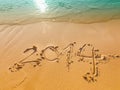 New Year 2014 written in sand on the beach Royalty Free Stock Photo