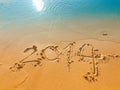 New Year 2014 written in sand on the beach Royalty Free Stock Photo