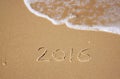 New year 2016 written in sandy beach. image is retro filtered. Royalty Free Stock Photo