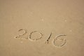 New year 2016 written in sandy beach. image is retro filtered. Royalty Free Stock Photo