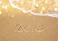 New year 2016 written in sandy beach. image is retro filtered Royalty Free Stock Photo