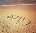 New year 2015 written on sandy beach. retro filtered image/ Royalty Free Stock Photo