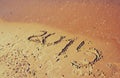 New year 2015 written on sandy beach. retro filtered image Royalty Free Stock Photo