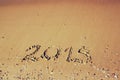 New year 2015 written on sandy beach. retro filtered image. Royalty Free Stock Photo