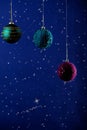 A New year's card. Beautiful cristmas decorations colored balls on a blue background with stars