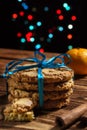New Year's Christmas oatmeal cookies, beautifully tied with a blue ribbon, close-up. Homemade cakes, gift, packaging