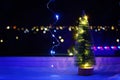 New Year's Christmas tree on the window on background of the night city. Garlands, lights, bokeh. Royalty Free Stock Photo