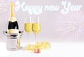 Champagne bottle with glasses against a blurred background with fireworks and the lettering Happy New Year