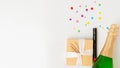 New Year& x27;s set - a gift, champagne and a cracker on a white background with a place for text