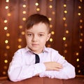 New Year xmas child. Christmas eve holiday. Beautiful portrait. Cute little boy. Brown background Royalty Free Stock Photo