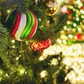 New year and xmas tree decorations with striped ball and red bauble, close-up Royalty Free Stock Photo