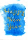 New Year. Yellow lettering on the blue watercolor background. Royalty Free Stock Photo