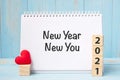 New Year New You words and 2021 cubes with red heart shape decoration on blue wooden table background. Goal, Resolution, health, Royalty Free Stock Photo