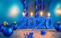 New years 2020 blue glitter candals with balloons and streamers