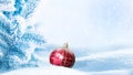 New Years Christmas card. Spruce snow-covered branches and Christmas ball against the background of snowfall. Copy space.