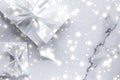 Luxury holiday gifts with white silk bow and ribbons on marble background, Christmas time surprise