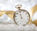 New Years eve countdown. Almost midnight on an old pocket watch, bokeh background Royalty Free Stock Photo