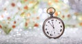 New Years eve countdown. Minutes to midnight on an old pocket watch, bokeh background Royalty Free Stock Photo