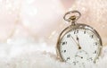 New Years eve party celebration. Minutes to midnight on an old watch, bokeh snowy Royalty Free Stock Photo