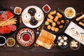 New Years Eve appetizer table scene. Above view on a dark wood background.