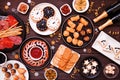 New Years Eve appetizer table scene. Overhead view on a dark wood background.