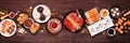 New Years Eve appetizer table scene. Top view on a dark wood banner background.