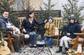 New Years family gatherings by winter bonfire in backyard outdoors