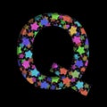 New Years font. The letter Q cut out of black paper on the background of bright colored stars of different sizes. Set of New Year