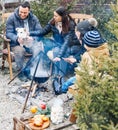 New Years gatherings by winter bonfire. Cozy portrait of happy family parents