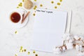 New Years goals written on a white mock-up notebook placed on a festive desk with a coffee cup Royalty Free Stock Photo