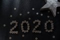 New Years 2020 graphic made from coins from Switzerland on a black shiny ground with silver star for concept Royalty Free Stock Photo