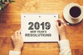 2019 New Years Resolutions with a person holding a pen Royalty Free Stock Photo