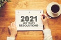 2021 New Years Resolutions with a person holding a pen Royalty Free Stock Photo