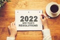 2022 New Years Resolutions with a person holding a pen Royalty Free Stock Photo