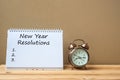 New years Resolutions text on notebook and retro alarm clock on table and copy space. Goals, Mission and New Start Royalty Free Stock Photo